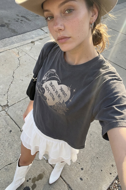 cowgirl,brunette,white skin,slim body,small tits,cowboy hat,boots,skirt,t-shirt,outdoor,teaser,freckles,ponytail