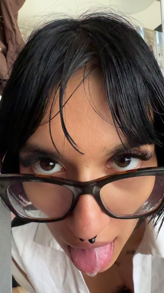 black hair,brunette,white skin,slim body,glasses,open shirt,tongue out,spit,close up,selfie,nose ring,makeup