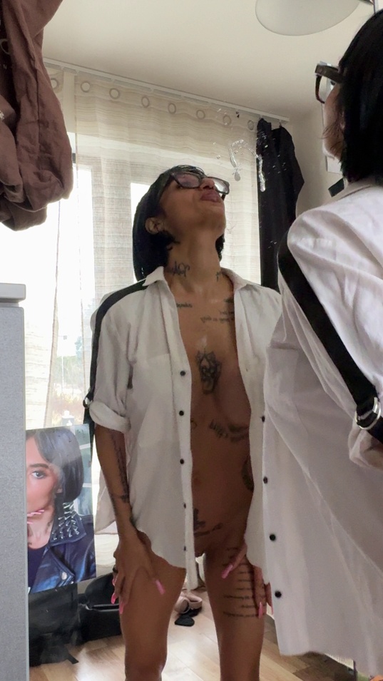 brunette,glasses,white shirt,open shirt,tongue out,drool,saliva string,tattoos,slim body,tan skin,medium tits,standing pose,teaser