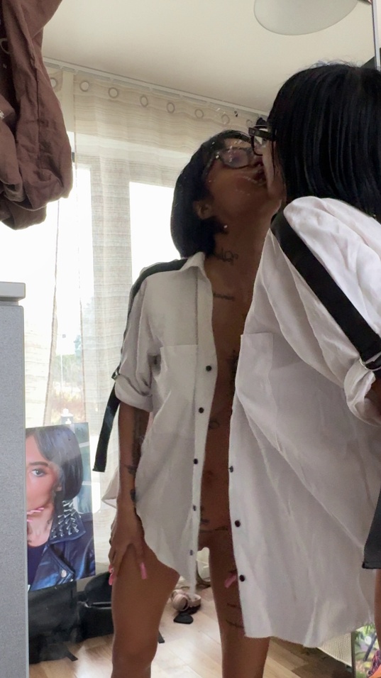 short hair,black hair,glasses,white shirt,unbuttoned shirt,open shirt,tattoos,slim body,tan skin,medium tits,lesbian,kissing,neck kiss,bedroom,teaser
