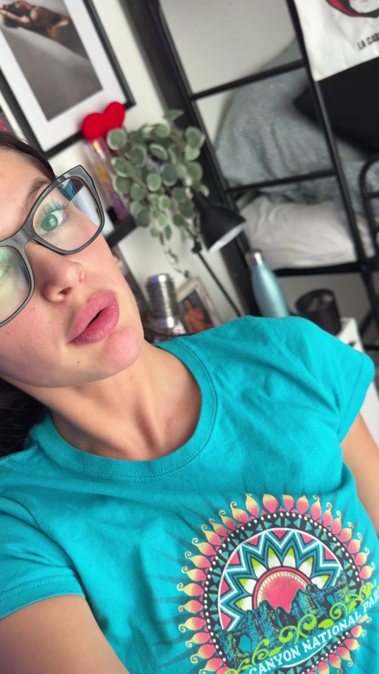 brunette,white girl,medium tits,slim body,glasses,turquoise t-shirt,selfie,bedroom,pouty lips,green eyes,dark hair,clothed teaser,t-shirt,mandala shirt